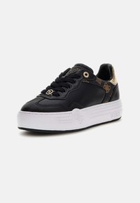 Black leather sneaker with a white rubber sole, gold accents on the heel, and patterned side detailing. Features round eyelets and laces.
