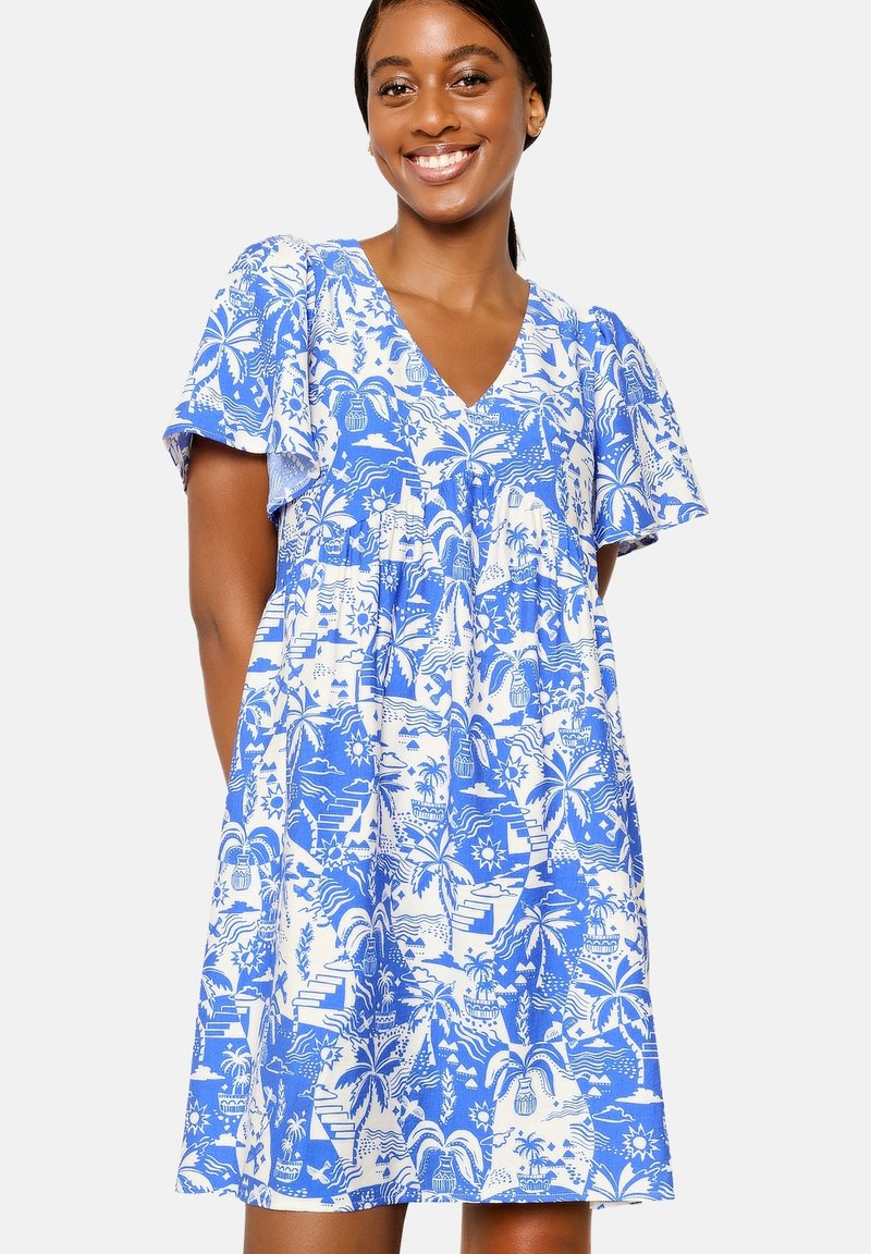 Blauwe en witte jurk met een patroon, korte vloeiende mouwen, V-halslijn en gelaagd ontwerp met tropische motieven en texturen.
