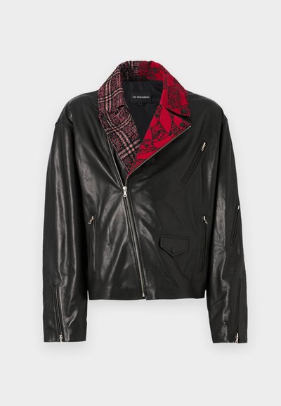 Black leather jacket with a red and gray patterned collar, multiple zip pockets, and angled zip closures on the sleeves.