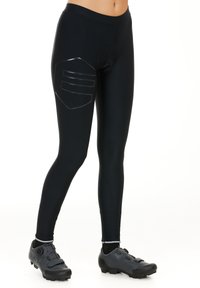 Black athletic leggings featuring a sleek design, elastic material, a padded area on the thigh, and paired with black cycling shoes.
