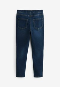 Donkerblauwe denim jeggings met een elastische tailleband, twee achterzakken en contrasterende stiksels. Aansluitend beenontwerp, geen voorzakken.