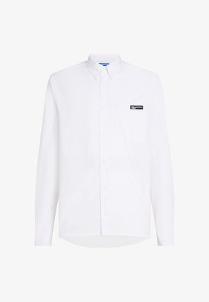 Fehér, hosszú ujjú ing zsebből, fekete logóval a mellrészen, sima pamutból készült.