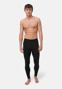 Schwarze dehnbare Leggings mit einer engen Passform und einem elastischen Bund. Der Stoff wirkt glatt und leicht strukturiert.