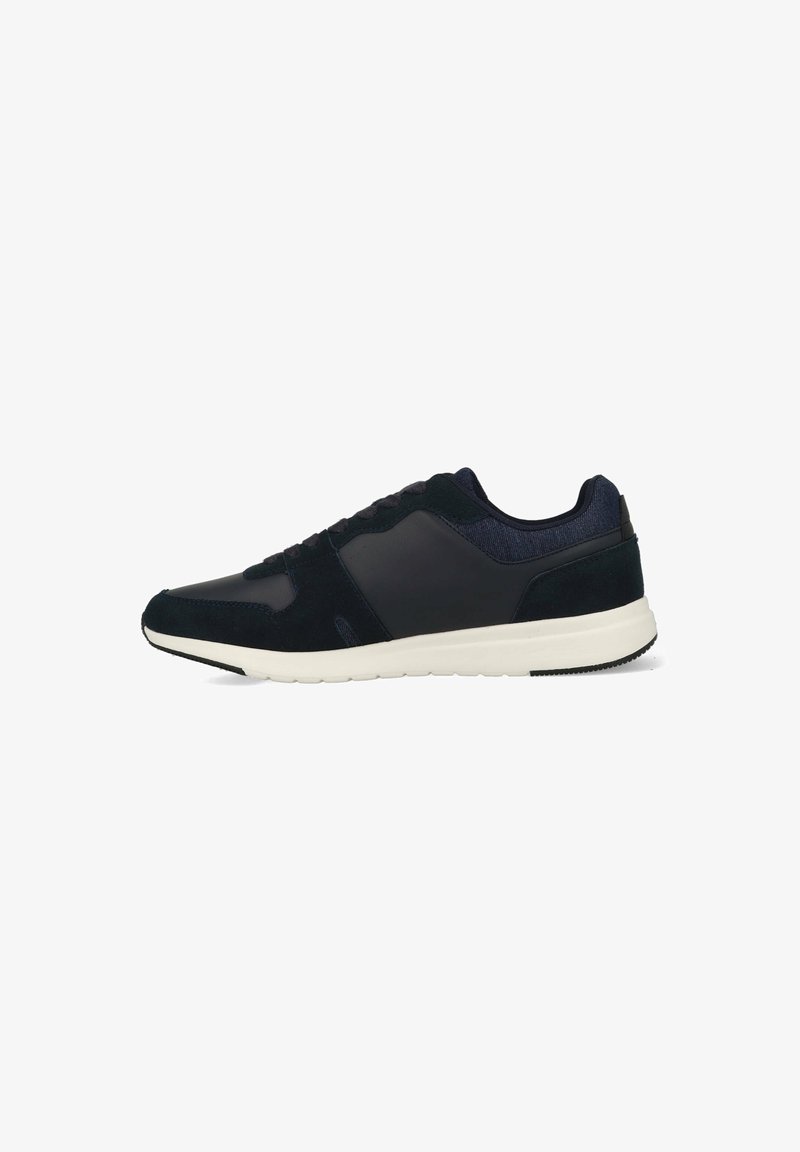 Navy blue athletic sneaker with a smooth leather and suede upper, contrasting white midsole, and a textured heel accent. Lace-up design.