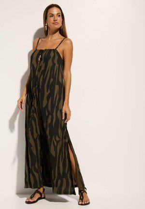 Robe maxi avec un motif abstrait vert et noir, dotée de bretelles spaghetti, d'évasements sur les côtés et d'une ouverture en forme de trou de serrure à l'avant. Matière légère.