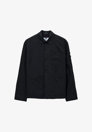 Giacca nera con bottoni, maniche lunghe, dotata di una tasca sul petto e due tasche frontali, realizzata in un tessuto liscio e strutturato.