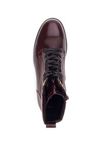 Bottines lacées noires en vernis rouge foncé avec des lacets noirs présentant de petits points jaunes, fermeture éclair sur le côté et languette sur fond blanc.