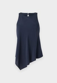 Tamnoplava bezrukavna majica s asimetričnim rubom, izrađena od mekog materijala. Ima otvor u obliku ključanice na leđima. Jednostavan, elegantan dizajn.