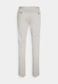 Helle graue, maßgeschneiderte Hose aus Baumwolle. Verfügbar mit flachem Bund, fünf Taschen und subtilen Nahtdetails. Glatte Textur und gerade Passform.