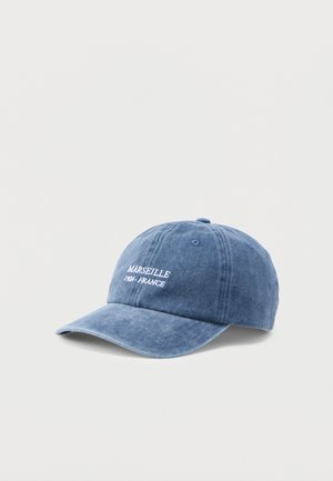 Blue washed cotton baseball cap with white embroidered text "MARSEILLE 1921 - FRANCE" on front, displayed against a plain light background.