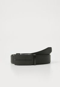 Black leather belt coiled with rectangular matte black metal buckle resting on a white surface.