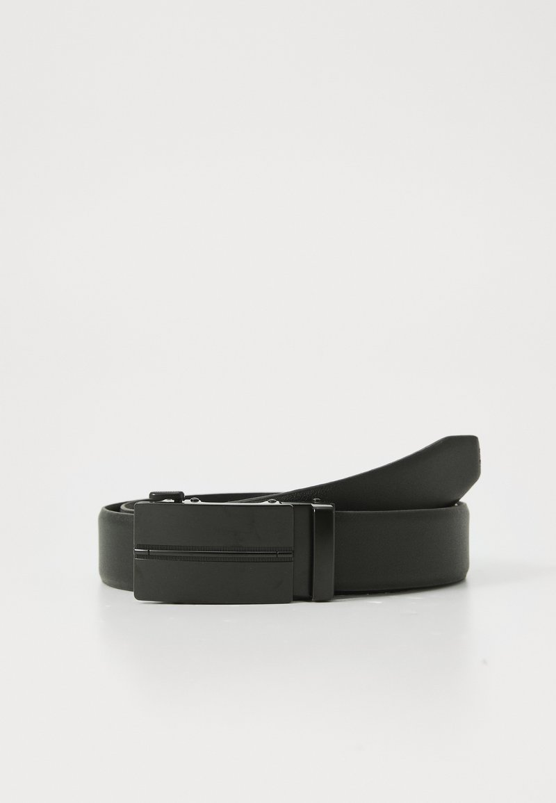 Black leather belt coiled with rectangular matte black metal buckle resting on a white surface.