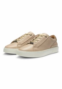 Beige leather sneakers with a smooth finish, rounded toe, elastic laces, and a white rubber sole. Subtle perforations on the sides.