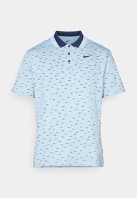 Light blue polo shirt with navy collar, featuring a repeated black pattern. Three-button placket and Nike logo on the chest.