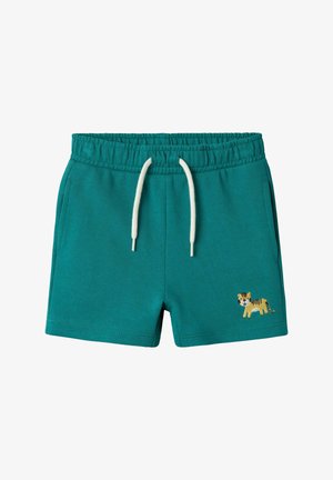 Teal cotton shorts with an elastic waistband, cream drawstring, side pockets, and an embroidered tiger detail on the left leg.