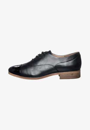 Chaussure en cuir noir avec un bout en cuir verni brillant, surface lisse, forme arrondie et petit talon empilé. Design minimaliste avec lacets.