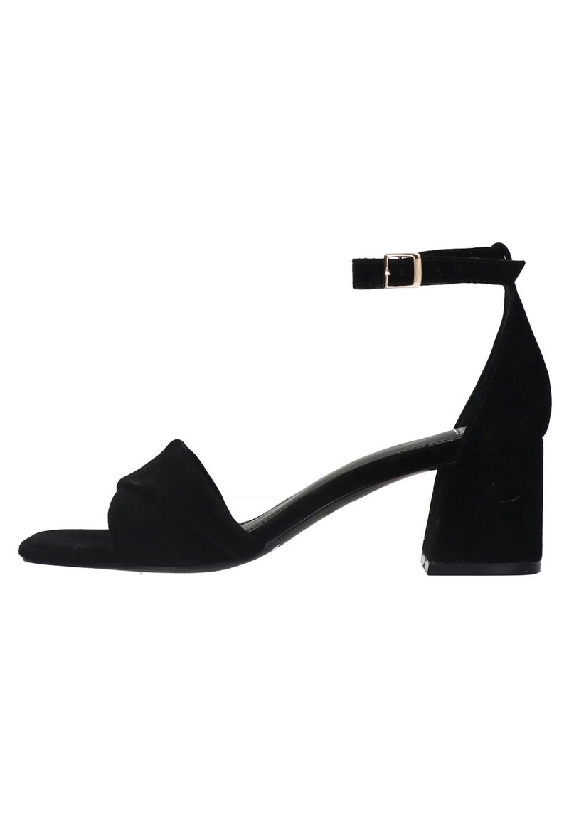 Black suede heeled sandal with a square toe, adjustable ankle strap, and block heel. Minimalistic design with a smooth texture.