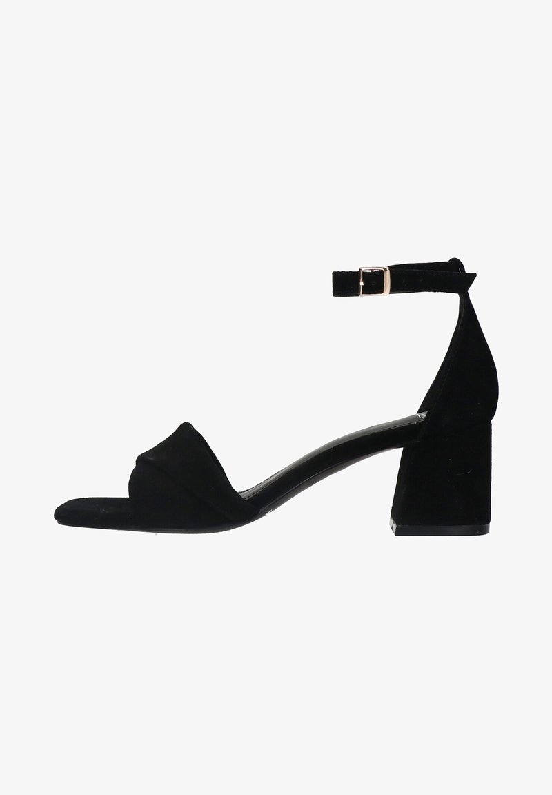 Black suede heeled sandal with a square toe, adjustable ankle strap, and block heel. Minimalistic design with a smooth texture.
