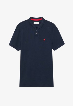 Námornícky polo tričko z bavlny s krátkymi rukávmi, rebrovaným golierom, dvojitým zapínaním na gombíky a malým červeným vtáčikom na hrudi.