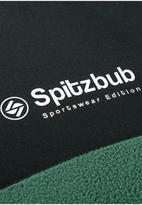 Black fabric sportswear featuring white text "Spitzbub" and "Sportswear Edition"; green fleece accent at the bottom with a circular logo.