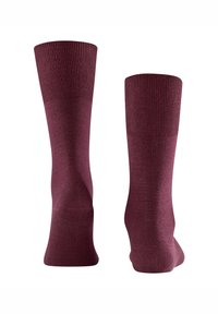 Viininpunaiset polven yli ulottuvat sukat, joissa on sileä pinta ja resorireunus. Suunnittelu on yksivärinen, sopiva erilaisiin tilaisuuksiin.
