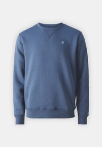 Felpa in cotone blu con maniche lunghe, polsini e orlo a costine, dettaglio a V, e un piccolo logo sul lato sinistro del petto.