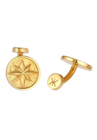 Gemelli in oro con un design circolare, con un'incisione a stella su un lato e un'estremità liscia e rotonda con un piccolo dettaglio inciso dall'altro lato.