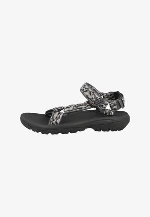 Sandal de patrón negro y gris con correas ajustables, suelas texturizadas y suela con dibujo, diseñado para brindar comodidad y tracción.