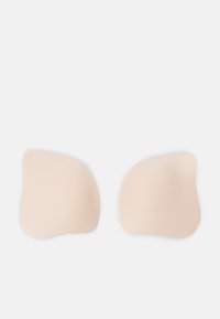 Skin-toned adhesive bra pads in a smooth, irregular shape with rounded edges, designed for discreet support under clothing.