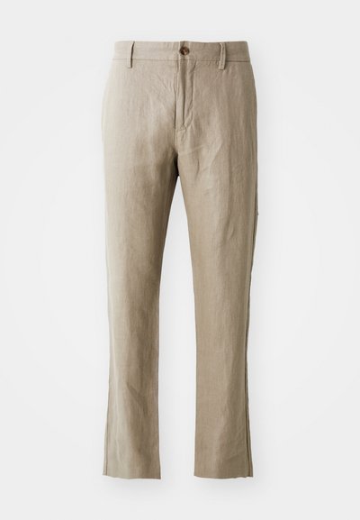 Bežist linased püksid sirge lõikega, ees nupuvärgiga kinnitamine ja sile tekstuur. Nähtavad muster ja aktsendid puuduvad.