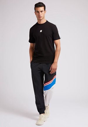 T-shirt con stampa - schwarz