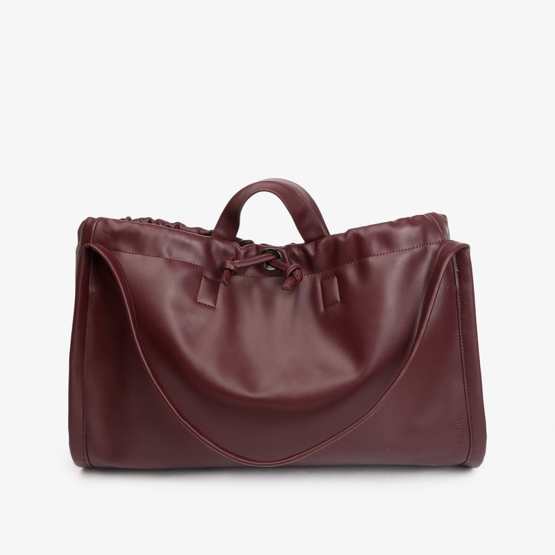 Large burgundy leather tote bag with a top handle, adjustable shoulder strap, and drawstring closure on a white background.