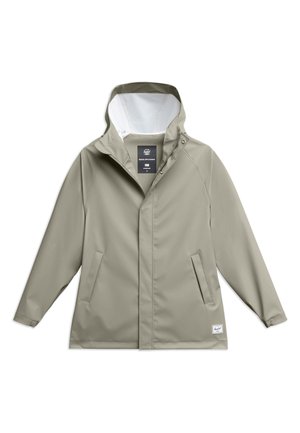Giacca leggera grigia resistente all'acqua con cappuccio, bottoni a pressione, tasche laterali e fodera interna bianca. Progettata per comfort e protezione.