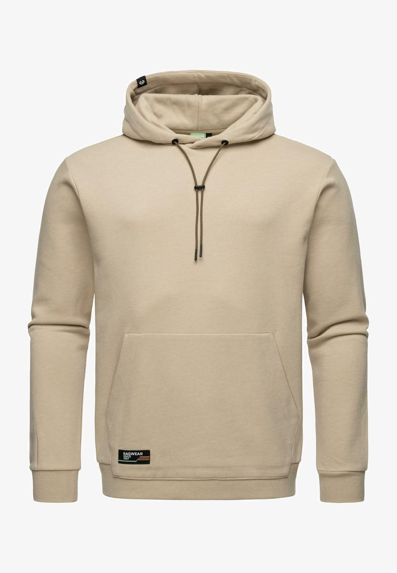 Bežs kapučinš, izgatavots no mīksta auduma, ar auklu kapuci, kangaroo kabatu, ribinātām piedurknēm un mazu zīmola etiķeti uz malām.