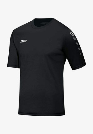 Schwarzes kurzärmliges T-Shirt aus glattem Stoff. Mit weißem "JAKO"-Branding auf der Vorderseite und drei Punktakzenten am linken Ärmel.