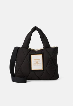 Black quilted tote bag with padded handles, detachable shoulder strap, and front label reading "Barbour South Shields" with lighthouse logo.