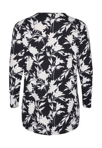 Top a maniche lunghe nero con motivo floreale bianco. Tessuto morbido, scollatura tonda e orlo curvo. Presenta delicati dettagli di foglie e fiori.