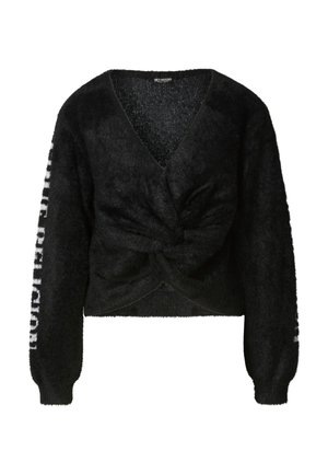 Fekete, bolyhos pulóver mély V-nyakkivágással és elől csavart dizájnnal. A hosszú ujjakon az egyik oldalon a "PUBLIC RELIGION" felirat olvasható.