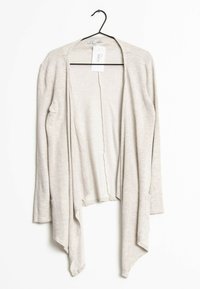 Světlé béžové kardigany, lehký pletený materiál, otevřený přední design, dlouhé rukávy, asymetrický spodní lem, obsahuje štítek na ramínku.