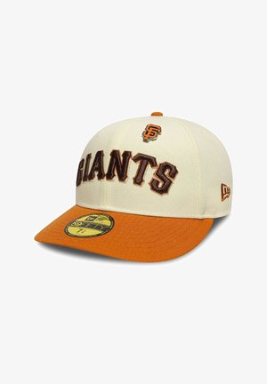 Cream cap with an orange visor, featuring "GIANTS" embroidered in brown and a logo patch. Structured design, curved brim, New Era tag visible.