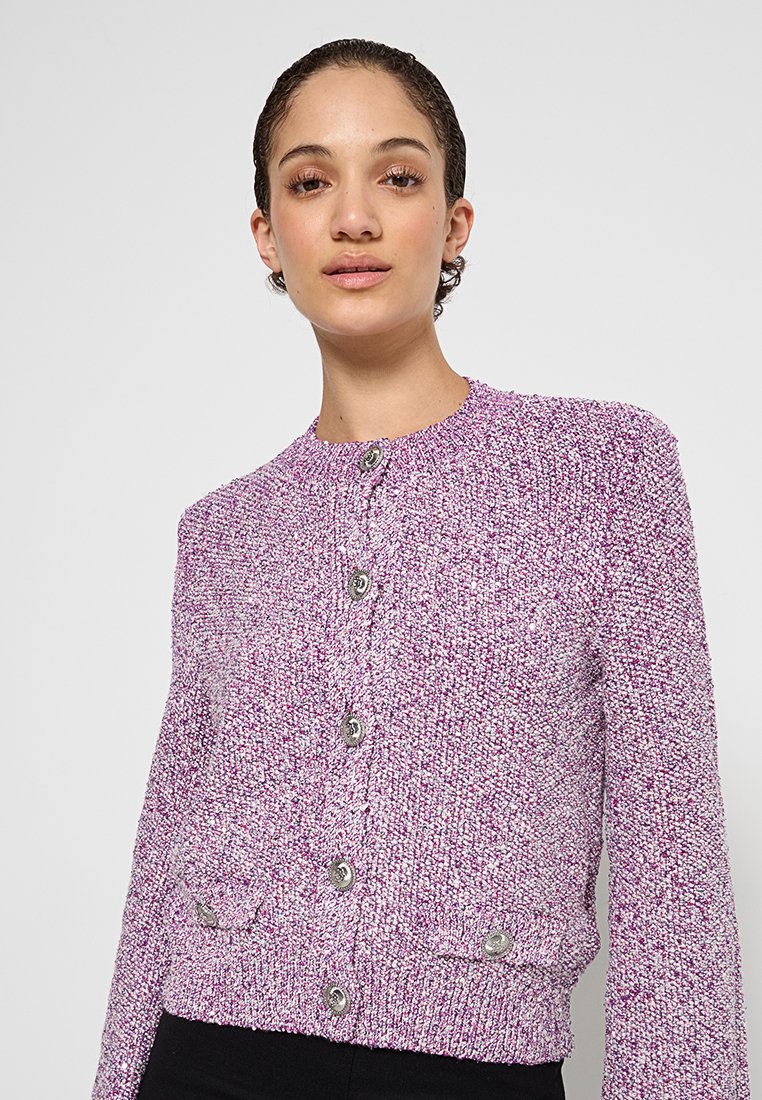 Lila gestrickte Strickjacke mit strukturiertem Muster, runder Ausschnitt und silbernen Knöpfen vorne. Verfügt über gestrickte Bündchen und eine enge Passform.