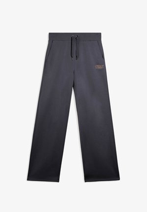 Pantaloni sportivi grigio scuro realizzati in morbido tessuto, con vita elasticizzata e cordino, tasche laterali e un piccolo logo dorato.
