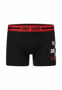 Schwarze Boxershorts mit einem roten elastischen Taillenbund mit dem Text "CAMP DAVID", weißen Druckgrafiken auf der Vorderseite und einem enganliegenden Design.