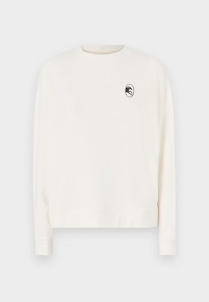 Dlhý rukáv smotanový sveter s okrúhlym výstrihom a čiernym logom v ovále na ľavej hrudi. Obsahuje rebrované manžety a lem.