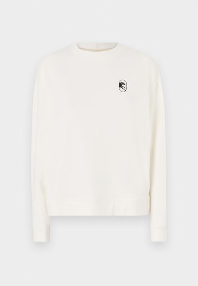 Langärmliges cremefarbenes Sweatshirt mit rundem Halsausschnitt und einem schwarzen Logo in einem Oval auf der linken Brust. Mit gerippten Bündchen und Saum.