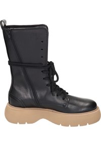 Botte lacée en cuir noir avec une fermeture éclair sur le côté, semelle en caoutchouc beige épaisse et bout arrondi. Présente une texture lisse et des coutures minimales.