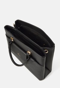 Black textured leather handbag with two zippered compartments, double handles with gold hardware, and a front pocket on a white background.