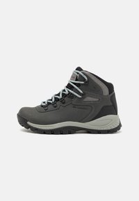 Gray hiking boot with textured leather and mesh upper, reinforced toe, and light blue laces. Features a rugged black rubber sole for traction.