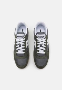Green and grey athletic shoes with white laces, mesh and suede material, round toe, and rubber sole. Saucony logo on side and tongue.