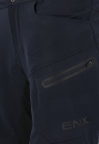 Marineblaue Hose mit glatter Textur, Reißverschlussaschentasche mit schwarzem Akzent und dem Markennamen "ENX" seitlich aufgedruckt.
